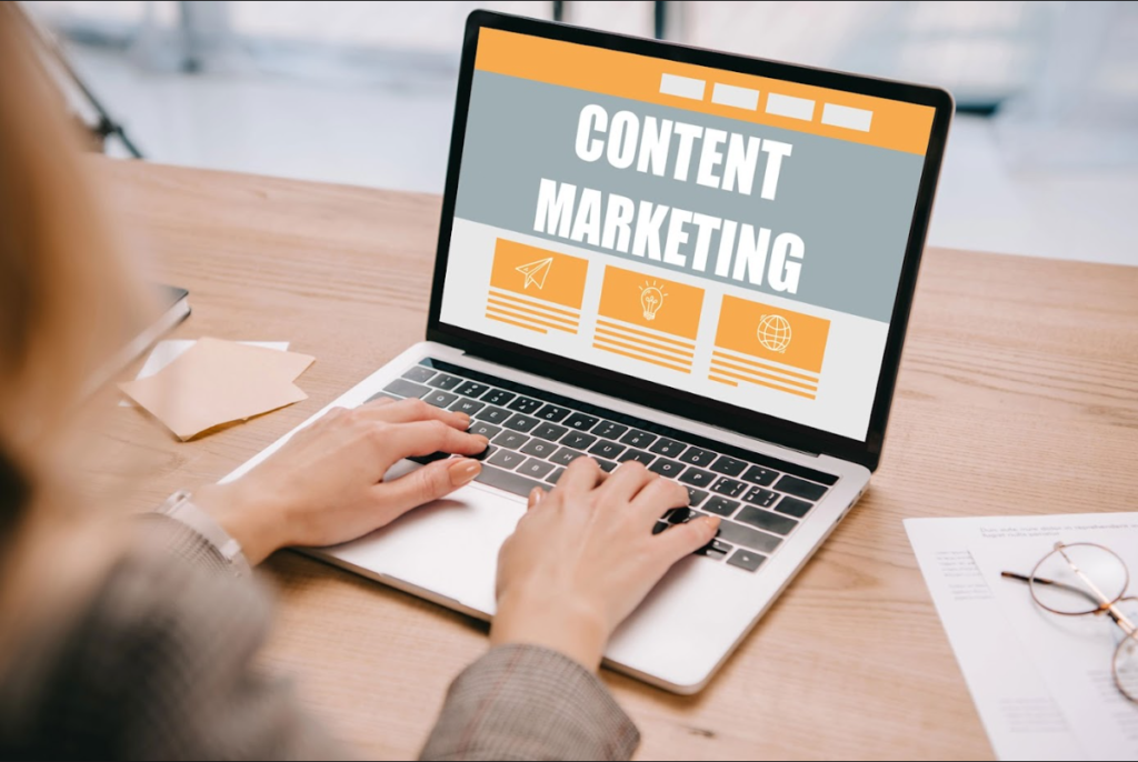 Luxe Drive Digital Marketing America's Top Marketing Agency A person typing on a laptop with a screen displaying "Content Marketing." Papers and a pen are on the desk. Luxe Drive Digital Marketing We Drive Your Growth