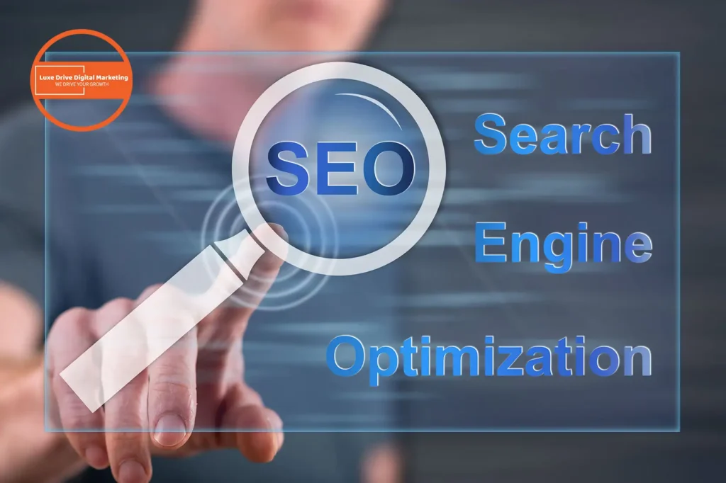 Luxe Drive Digital Marketing America's Top Marketing Agency A person pointing at a transparent screen displaying the words "SEO," "Search Engine," and "Optimization" alongside a magnifying glass graphic. Luxe Drive Digital Marketing We Drive Your Growth