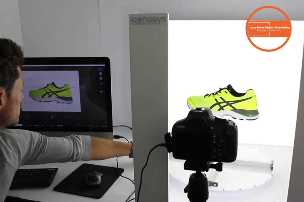 Luxe Drive Digital Marketing America's Top Marketing Agency A person photographs a neon green sneaker using professional equipment, including a computer and camera, in a studio setting. Luxe Drive Digital Marketing We Drive Your Growth