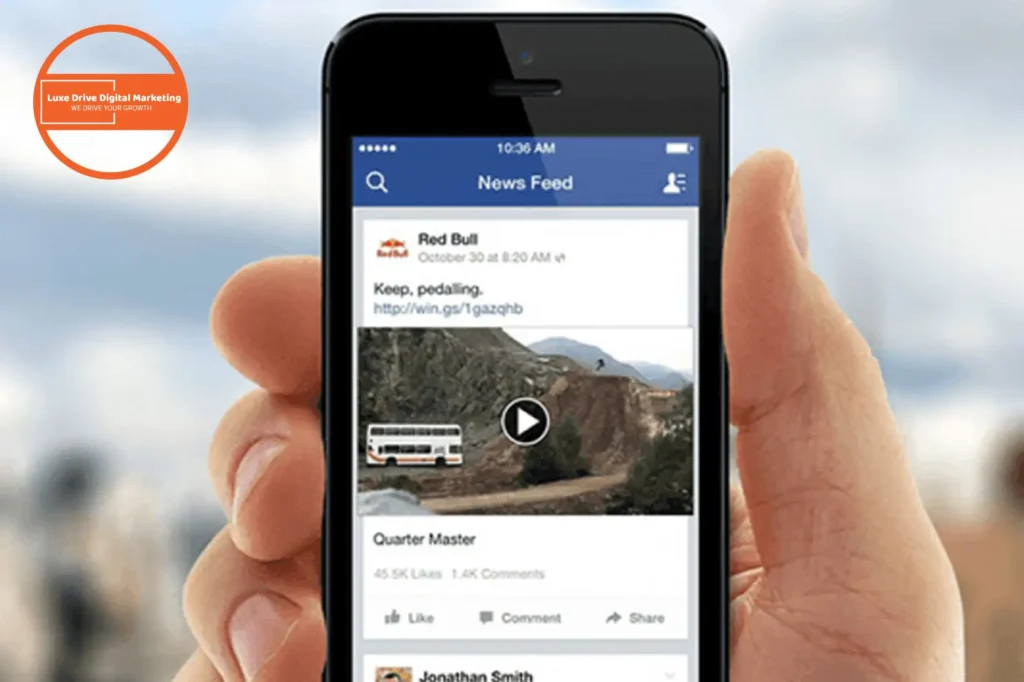 Luxe Drive Digital Marketing America's Top Marketing Agency A hand holds a smartphone displaying a social media news feed with a video post featuring a bus on a mountain road. Luxe Drive Digital Marketing We Drive Your Growth