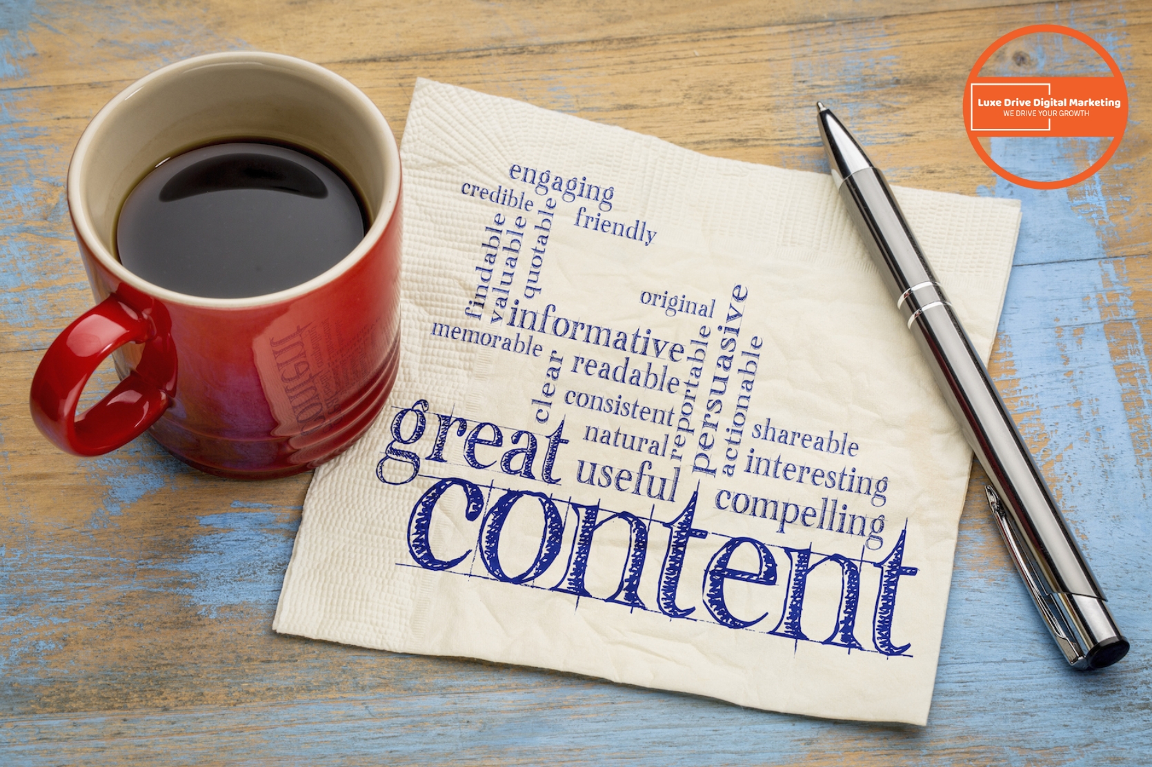 Luxe Drive Digital Marketing America&#039;s Top Marketing Agency A red coffee mug, a silver pen, and a napkin with a word cloud related to &quot;great content&quot; on a wooden table; a digital marketing logo appears in the top right corner. Luxe Drive Digital Marketing We Drive Your Growth