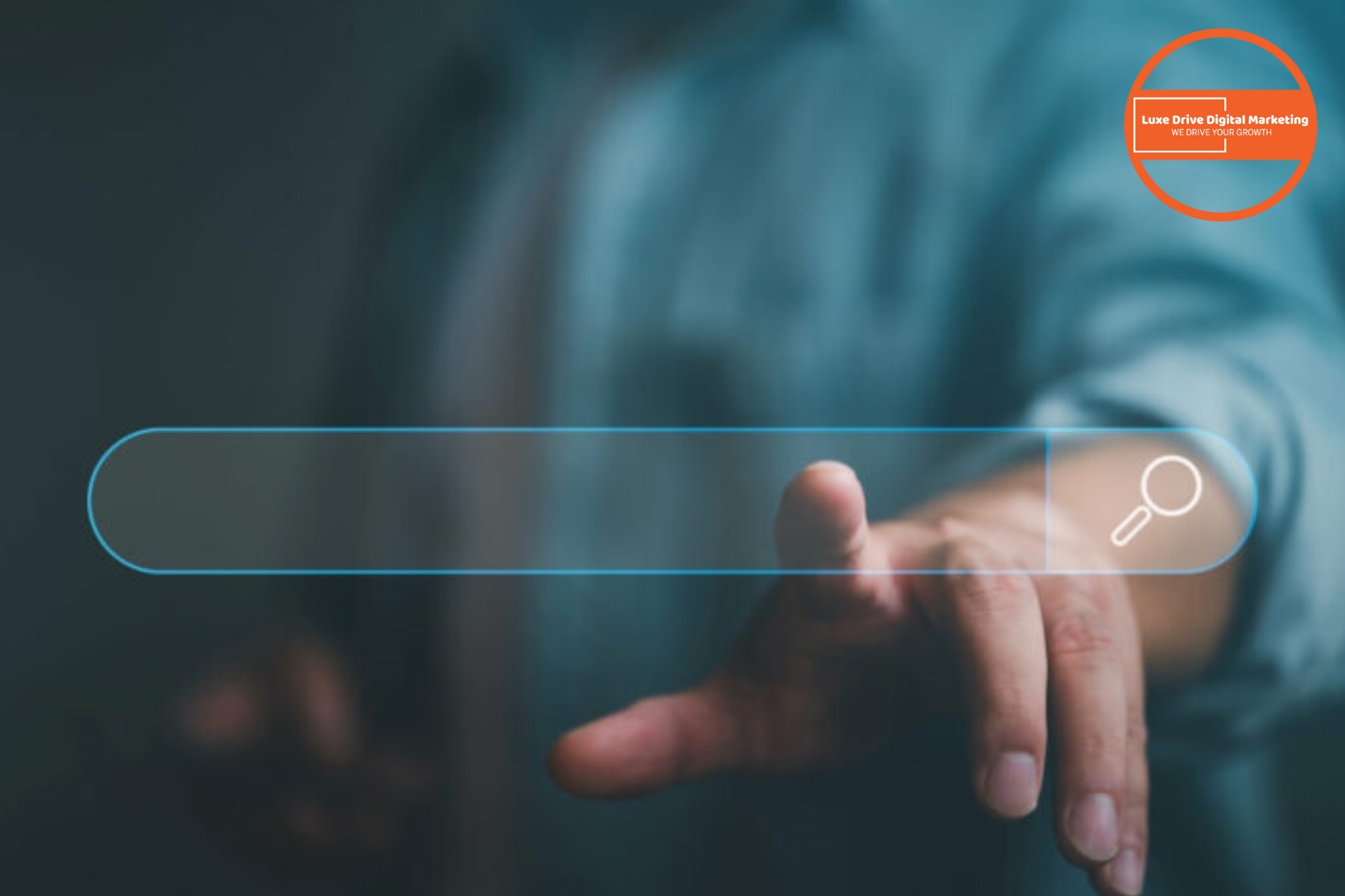 Luxe Drive Digital Marketing America&#039;s Top Marketing Agency A person extends their hand toward a digital search bar interface, with a blurry background and a logo reading &quot;Love Drive Digital Marketing&quot; in the top right corner. Luxe Drive Digital Marketing We Drive Your Growth